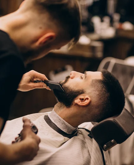 fa1d23e0-f8ef-4969-9feb-d2478a704425-man-barbershop-salon-doing-haircut-beard-trim.jpg